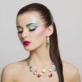 Beautiful fashion portrait of young woman with bright colorful makeup