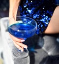 Beautiful fashion woman drink blue glitter martini cosmopolitan cocktail Royalty Free Stock Photo