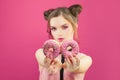 Beautiful fashion woman holding donut on vivid pink background Royalty Free Stock Photo