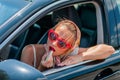 Beautiful fashion woman putting on lipstick in the car. Royalty Free Stock Photo