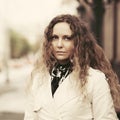 Beautiful fashion woman in trench coat walking on city street Royalty Free Stock Photo