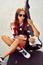 Beautiful and fashion young woman posing with guitar Royalty Free Stock Photo