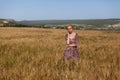 Beautiful fashionable blonde woman in a field of yellow ripe wheat Royalty Free Stock Photo