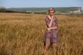 Beautiful fashionable blonde woman in a field of yellow ripe wheat Royalty Free Stock Photo