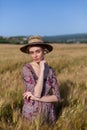 Beautiful fashionable blonde woman in a field of yellow ripe wheat Royalty Free Stock Photo