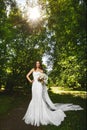 Beautiful and fashionable brunette model woman with a sexy perfect body, in the white stylish wedding dress, posing with Royalty Free Stock Photo