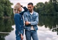 Beautiful fashionable couple posing on river bridge Royalty Free Stock Photo