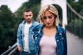 Beautiful fashionable couple posing on river bridge Royalty Free Stock Photo