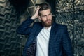 Beautiful fashionable man fixes his hair. dressed in suit Royalty Free Stock Photo