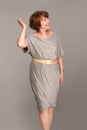 Beautiful fashionable mature woman in grey dress