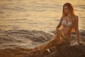 Beautiful mermaid sitting on a rock Royalty Free Stock Photo