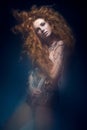 Beautiful fashionable red-haired girl in transparent dress, mermaid image with creative hairstyle curls. Fashion beauty style. Royalty Free Stock Photo