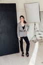 Beautiful fashionable woman brunette clothes business portrait costume in photo studio