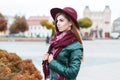 Beautiful fashionable woman in a hat and scarf posing in the cit Royalty Free Stock Photo