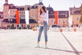 Beautiful Fashionable Young Adult Girl using her iphone on the outdoor at Summertime Royalty Free Stock Photo