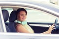 Beautiful and fashionable young woman driving her new car while listening music Royalty Free Stock Photo