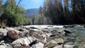 beautiful fast mountain stream with clear water at summer day - photo of nature Royalty Free Stock Photo