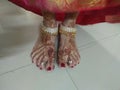 Beautiful feet of Indian women enhanced with herb design and graceful silver gold payal Royalty Free Stock Photo