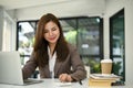 Beautiful female accountant using calculator and working on her account sales report Royalty Free Stock Photo