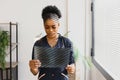 beautiful female african medical worker holding x-ray.