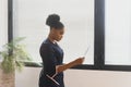 beautiful female african medical worker holding x-ray.