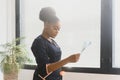 beautiful female african medical worker holding x-ray.