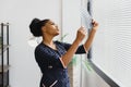 beautiful female african medical worker holding x-ray.