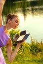 Woman dancing at sunset while holding a light box