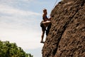 Female climber posing on a sheer rock Royalty Free Stock Photo