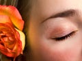 Beautiful female closed eye and rose close-up Royalty Free Stock Photo