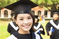 Beautiful female college graduate with classmates at ceremony Royalty Free Stock Photo