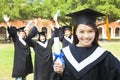 Beautiful female college graduate holding a diploma at ceremony Royalty Free Stock Photo