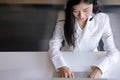 Beautiful female customer services agent with headset working in a call center office Royalty Free Stock Photo