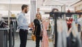 Beautiful Female Customer Shopping in Clothing Store, Retail Sales Associate Helps with Advice Royalty Free Stock Photo