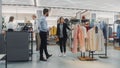 Beautiful Female Customer Shopping in Clothing Store, Retail Sales Associate Helps with Advice