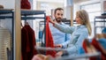 Beautiful Female Customer Shopping in Clothing Store, Retail Sales Associate Helps with Advice Royalty Free Stock Photo