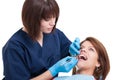 Beautiful female dentist performing oral exam