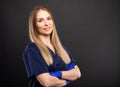 Beautiful female dentist wearing scrubs posing with arms crossed Royalty Free Stock Photo