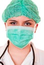 Beautiful female doctor with green mask and cap