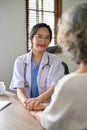 A beautiful female doctor holds a patient`s hand to comfort and reassure the patient Royalty Free Stock Photo