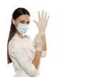 Beautiful female doctor or nurse wearing protective mask and latex or rubber gloves on white background with copyspace Royalty Free Stock Photo