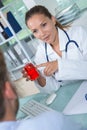 Beautiful female doctor showing capsule to patient Royalty Free Stock Photo
