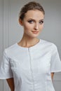 Beautiful female doctor in white clothes. Portrait of attractive medic in white robe Royalty Free Stock Photo