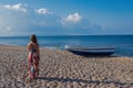 Beautiful female in the dress near boat on the sand Royalty Free Stock Photo