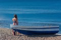 Beautiful female in the dress near boat on the sand Royalty Free Stock Photo