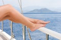 Beautiful female feet against the sea cruise landscape. Rest on a yacht Royalty Free Stock Photo