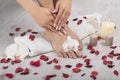 Beautiful female feet and hands with french manicure on white towel. Royalty Free Stock Photo