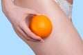 Beautiful female figure with an orange holds near the Royalty Free Stock Photo