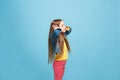 Beautiful female half-length portrait on blue studio backgroud. The young emotional teen girl Royalty Free Stock Photo