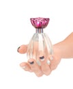 Beautiful female hand holding the bottle of perfume isolated on Royalty Free Stock Photo